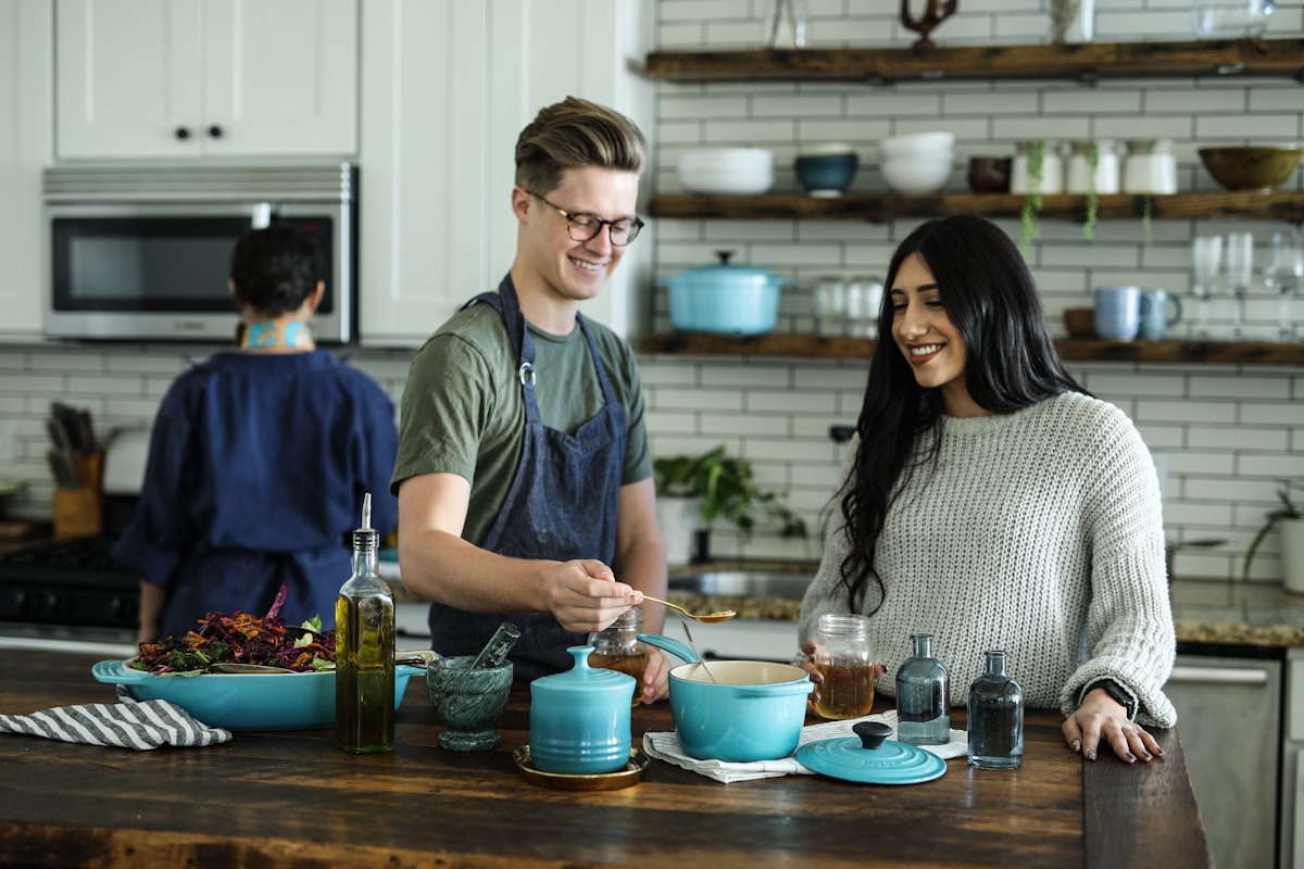 Hands preparing food at a wooden kitchen counter